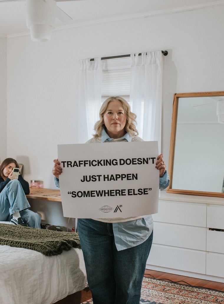 Global Freedom Summit 2026. Lady holding up sign