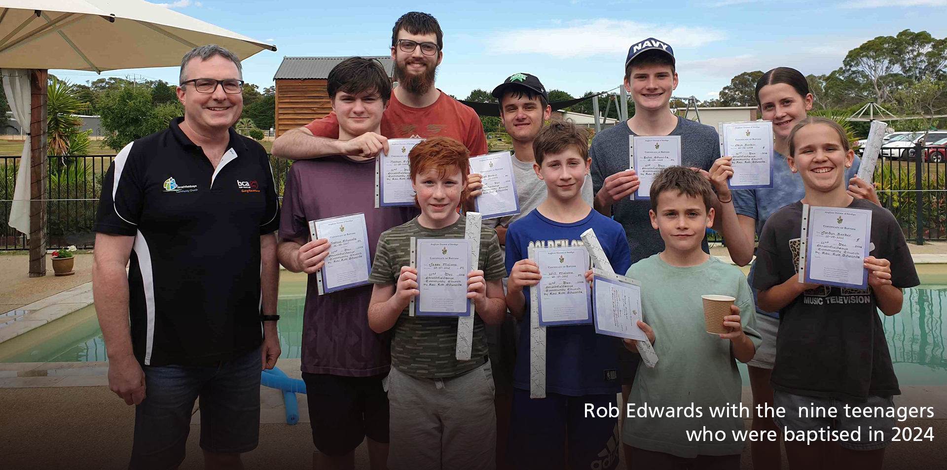 Rob Edwards with the nine teenagers who were baptised towards the end of 2024