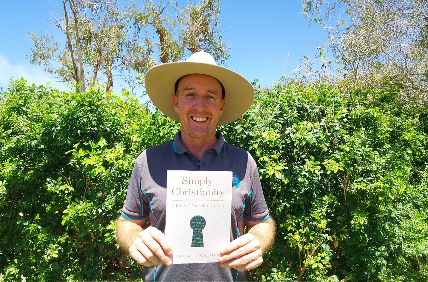 Frank holds a copy of the Simply Christianity book