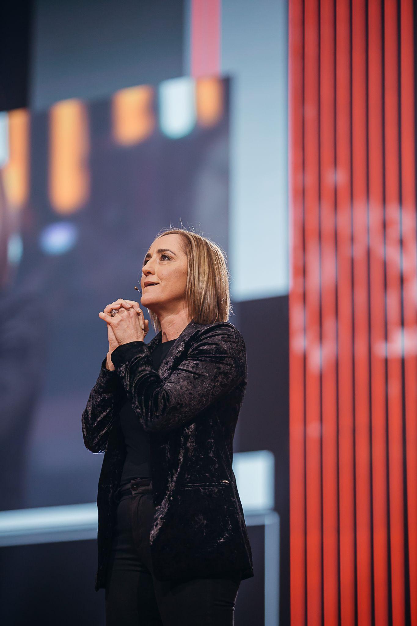 Christine Caine praying on stage